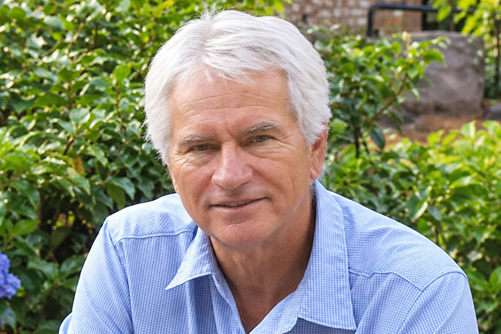 Portrait of a mature man outdoors in a blue check shirt.