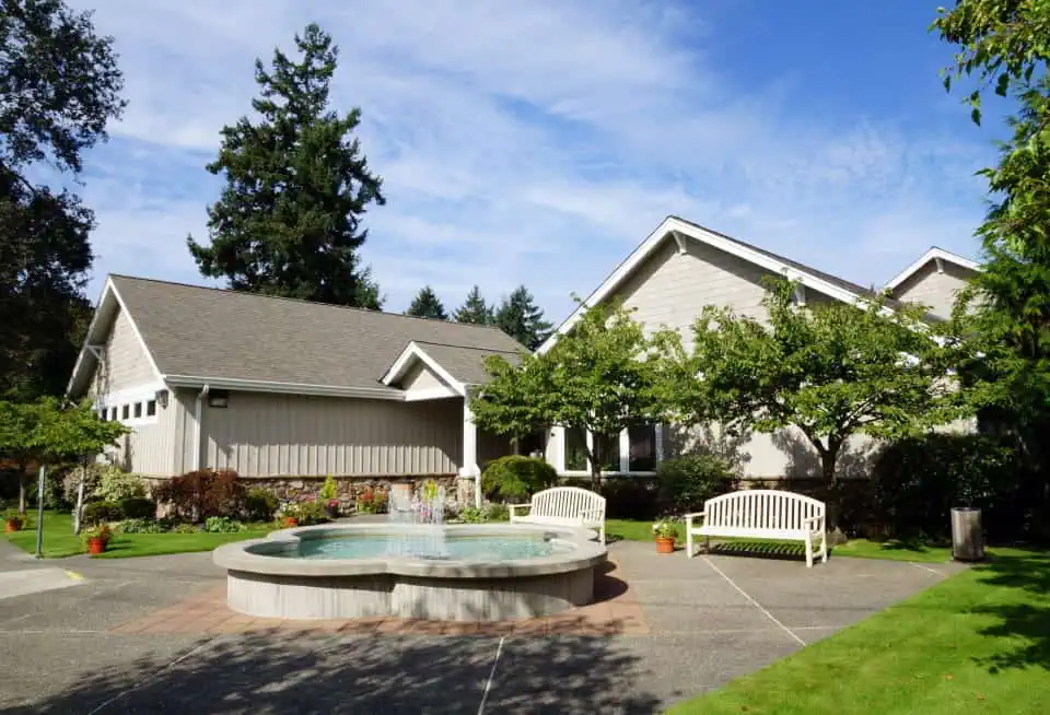 Main building of Mountain View Memorial Park with garden and benches.