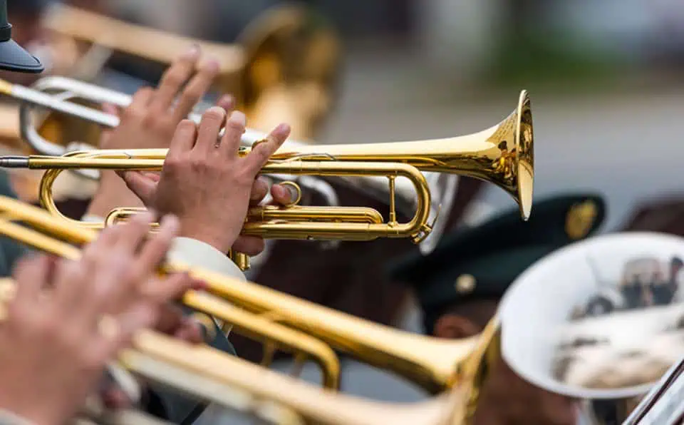 Musicians playing brass instruments at a memorial event.
