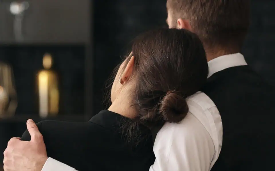 A couple shares a comforting hug at Mountain View Memorial Park.