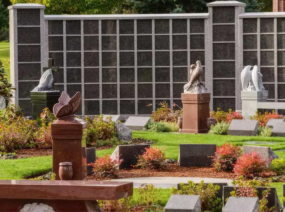 Sculptures of horses and a butterfly in a memorial garden setting.