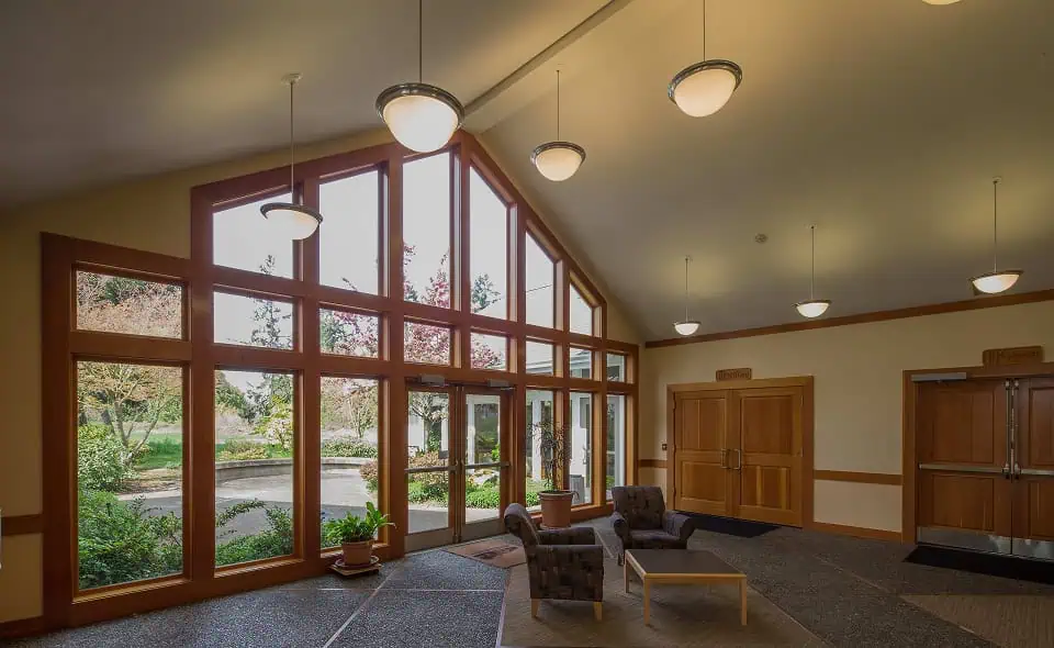 Spacious memorial lounge with large windows and comfortable seating.